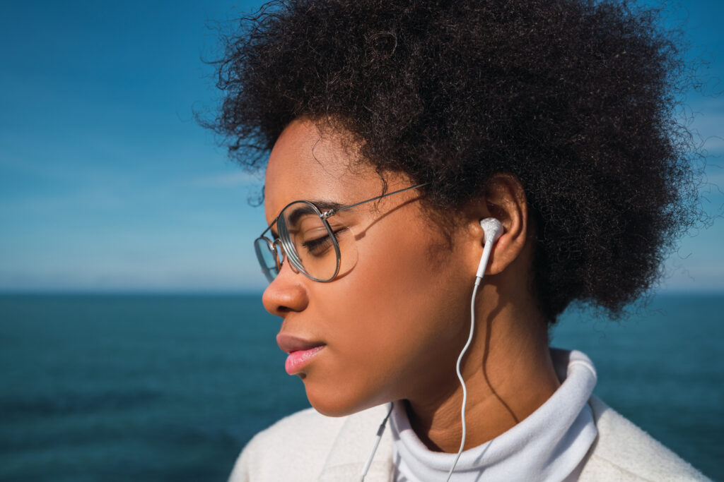 Woman listening to music with earphones.